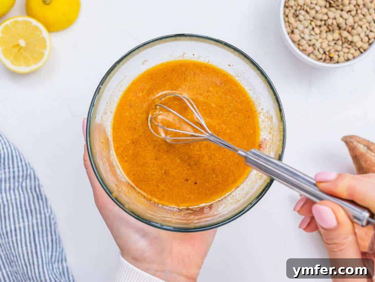 Wholesome Quinoa Lentil Delight 7 Step 3: A small bowl filled with the zesty lemon-mustard dressing, freshly prepared.