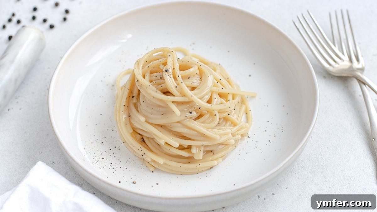 Creamy Vegan Pepper Pasta 3 Close-up of a bowl of vegan cacio e pepe, showing the creamy sauce and fresh pasta.