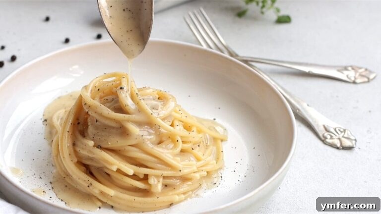 Creamy Vegan Pepper Pasta 25 Beautifully plated vegan Cacio e Pepe, garnished with extra sauce and pepper.