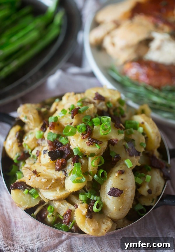 Savory Warm Potato Salad with Bacon and Fresh Herbs 2 A beautifully presented warm bacon herb potato salad, garnished with fresh herbs, showcasing the crispy bacon and tender potatoes, ready to be served as a comforting winter side dish.