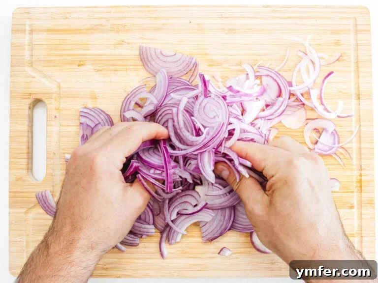 hands massaging red onions