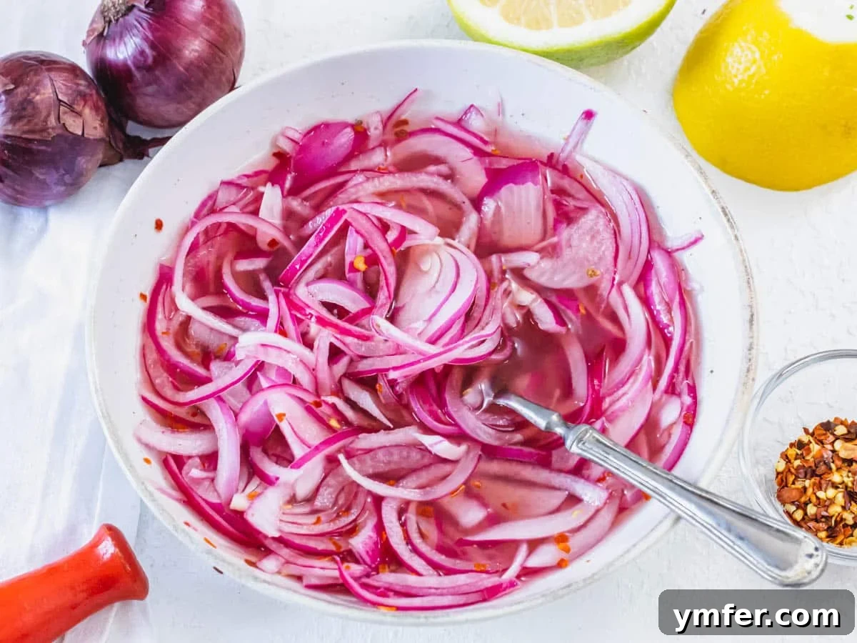 Flavorful Onion Dishes 4 Vibrant pickled red onions with a fork in a jar