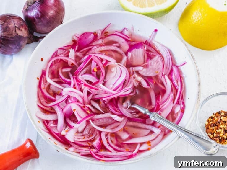 Pickled red onions with a fork