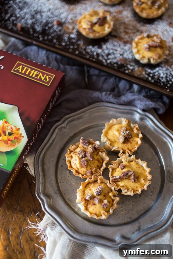 Crisp Phyllo No-Bake Pumpkin Cheesecake Bites 3 Close-up of fluffy spiced pumpkin cheesecake phyllo bites with pecans, showcasing the crunchy phyllo shells.