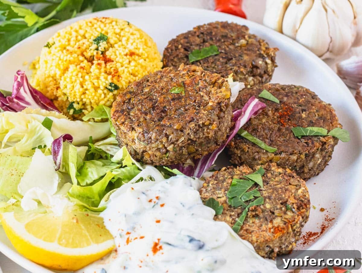 Spiced Lentil Delights 6 A plate of perfectly pan-fried lentil patties served alongside a creamy tzatziki sauce, garnished with fresh herbs.