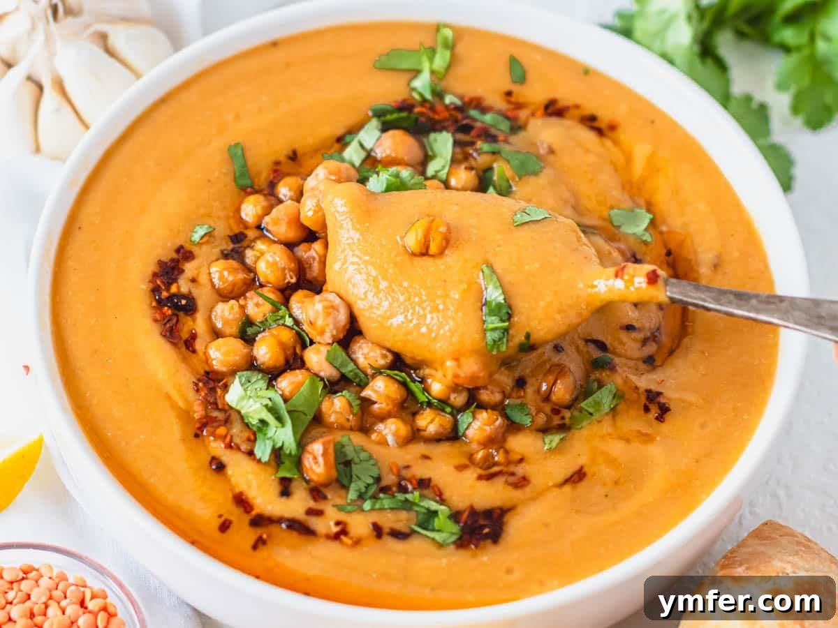 Turkish red lentil soup with roasted chickpeas and fresh cilantro on top