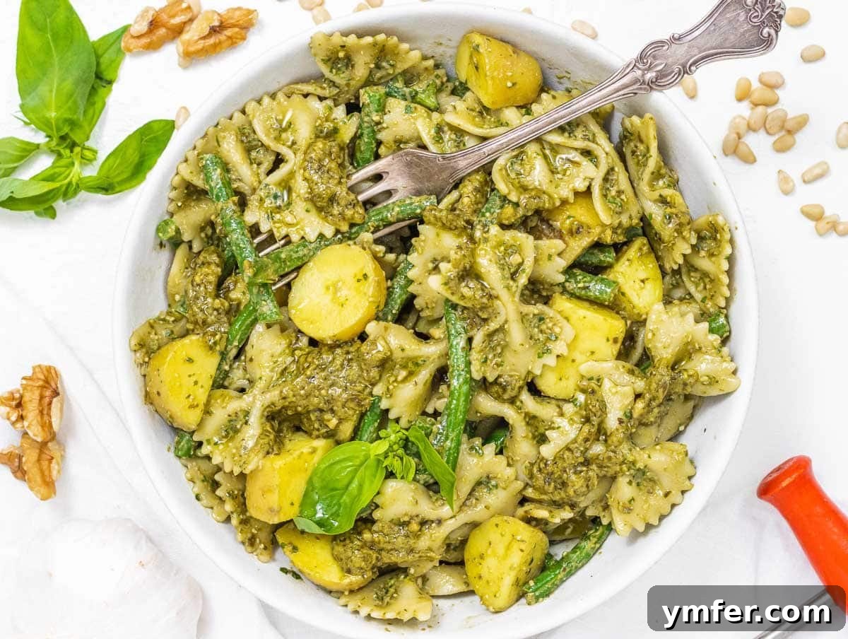 Protein-Packed Pasta Creations 14 Pesto pasta served with green beans and small potatoes, a vibrant and complete meal.