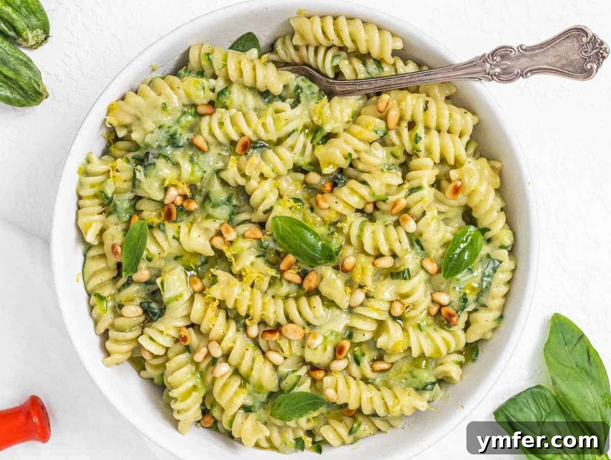 Protein-Packed Pasta Creations 18 Zucchini Pasta in a bowl with a fork, highlighting its fresh and vibrant appearance.