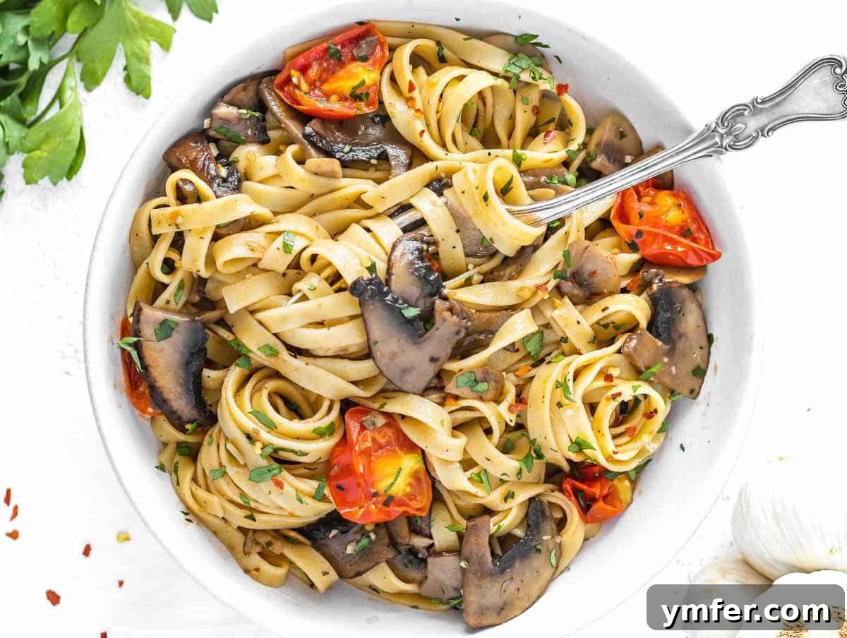 Protein-Packed Pasta Creations 23 Vegan Mushroom Pasta served with a silver fork, highlighting the rich sauce and mushrooms.