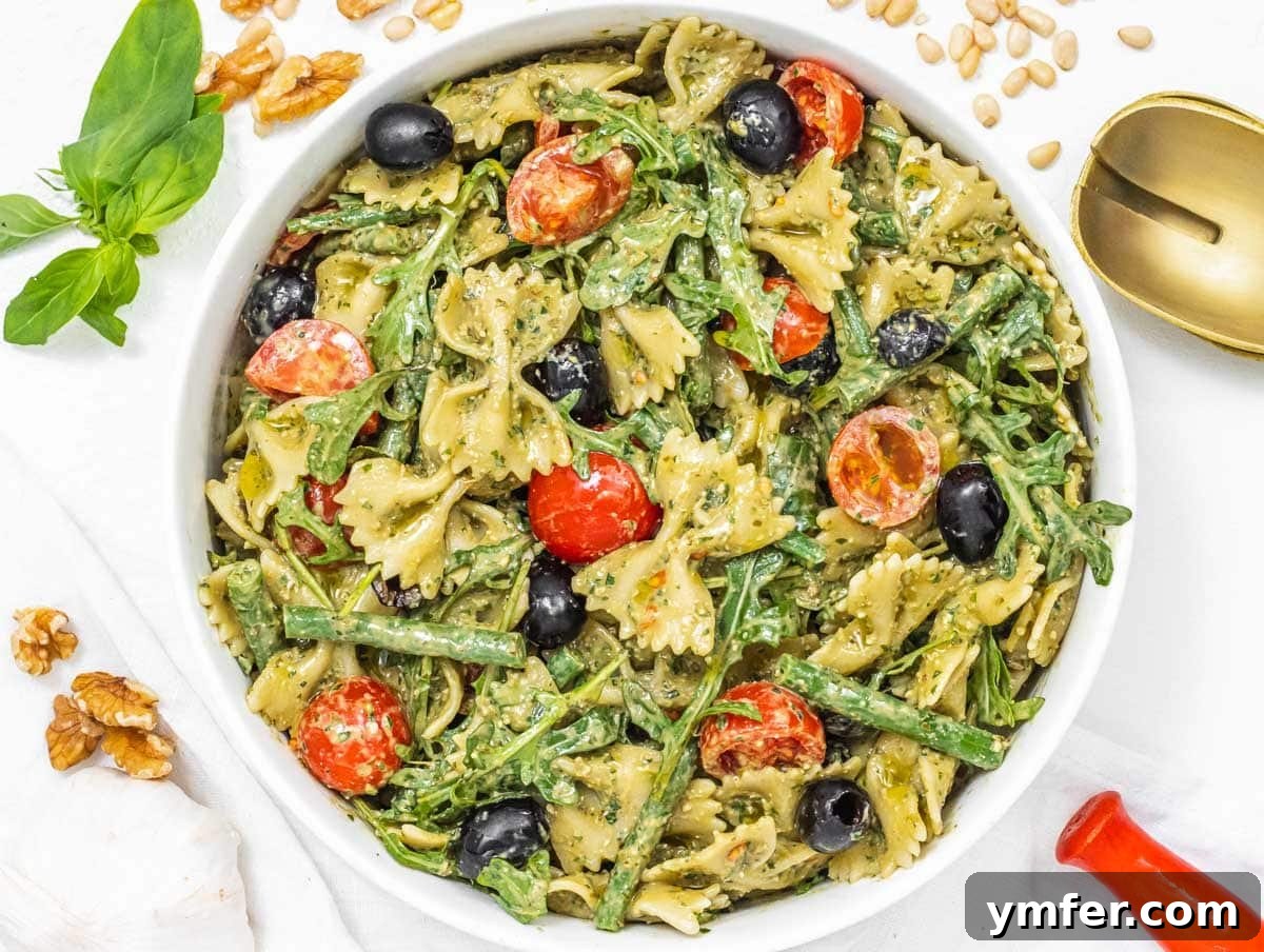 Protein-Packed Pasta Creations 27 Pesto pasta salad garnished with walnuts, a refreshing and hearty dish.