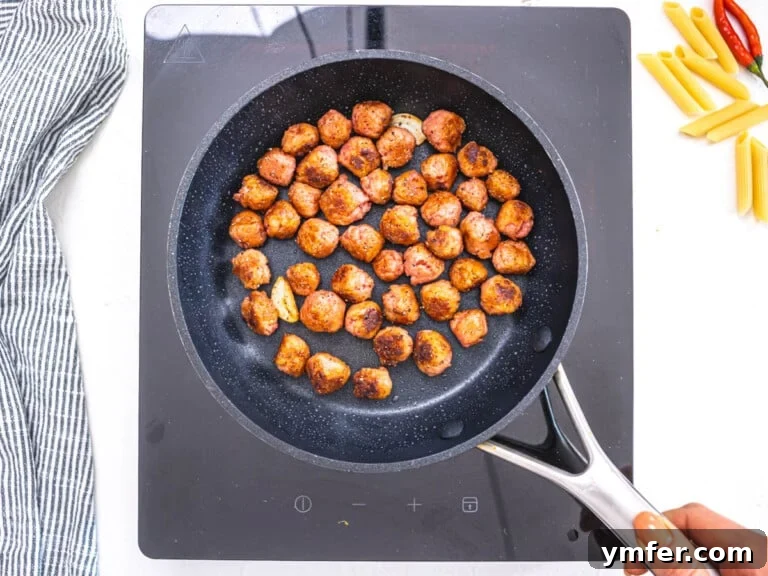 plant based sausage in a black small skillet