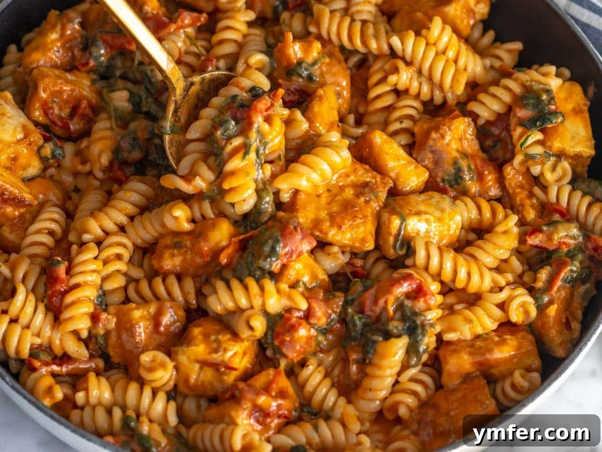 Protein-Packed Pasta Creations 5 Creamy tofu pasta served in a skillet, showcasing a hearty plant-based meal.