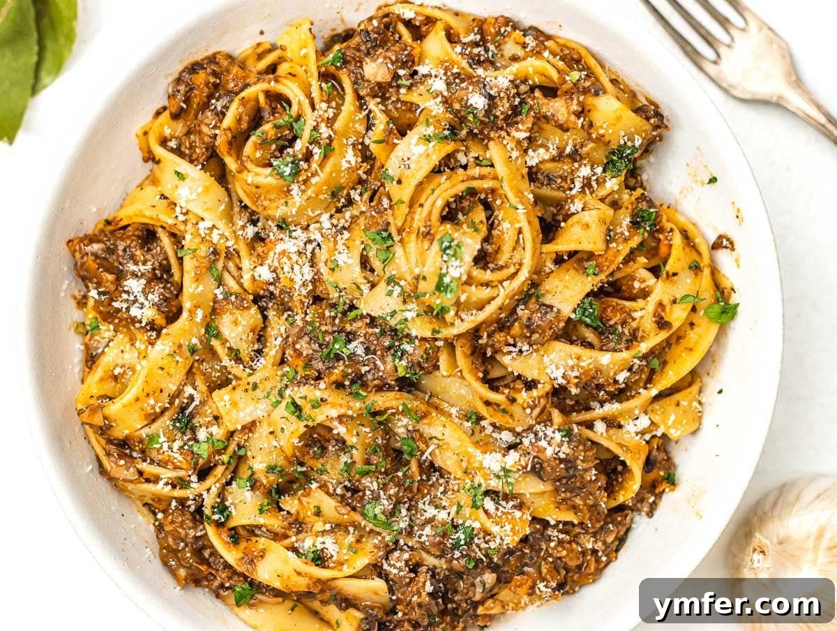 Protein-Packed Pasta Creations 7 Hearty Mushroom Bolognese with a sprinkle of vegan parmesan cheese.