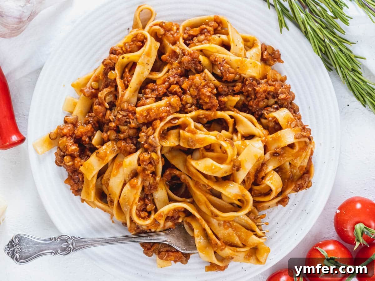 Protein-Packed Pasta Creations 8 Delicious Lentil Bolognese served on a white plate, showcasing its rich texture.