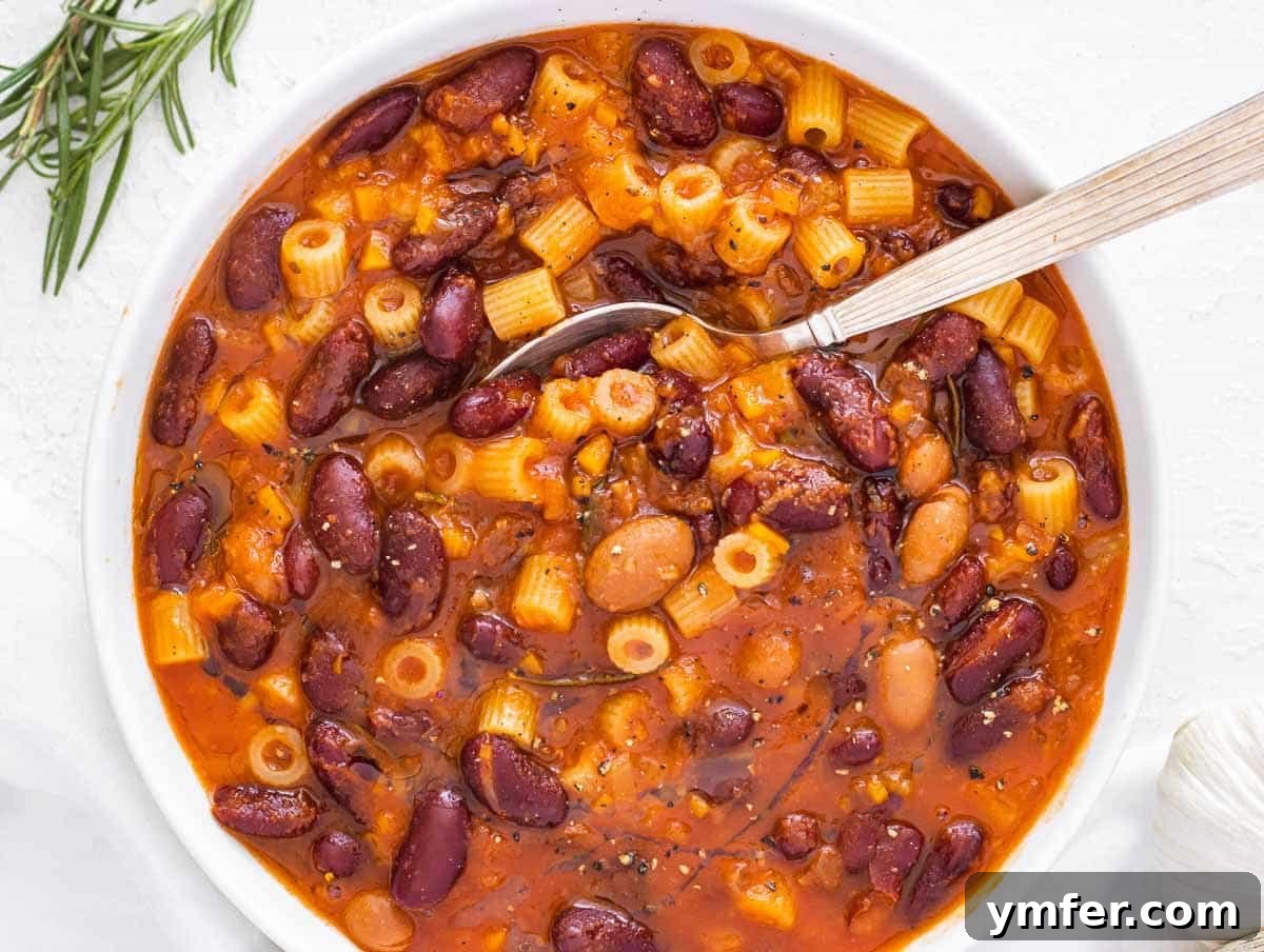 Protein-Packed Pasta Creations 10 A warm bowl of Pasta e Fagioli with a spoon, inviting and comforting.