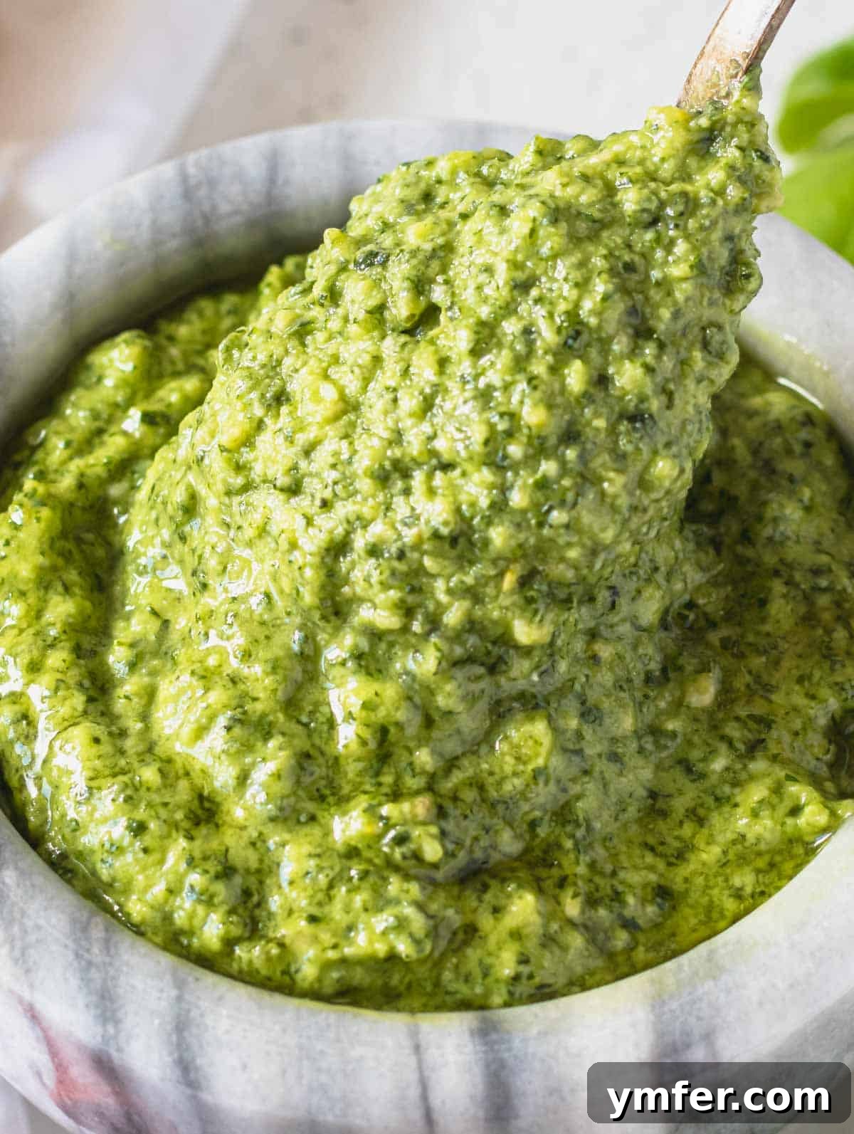Fresh Basil Pesto 2 basil pesto in a marble mortar with a spoon