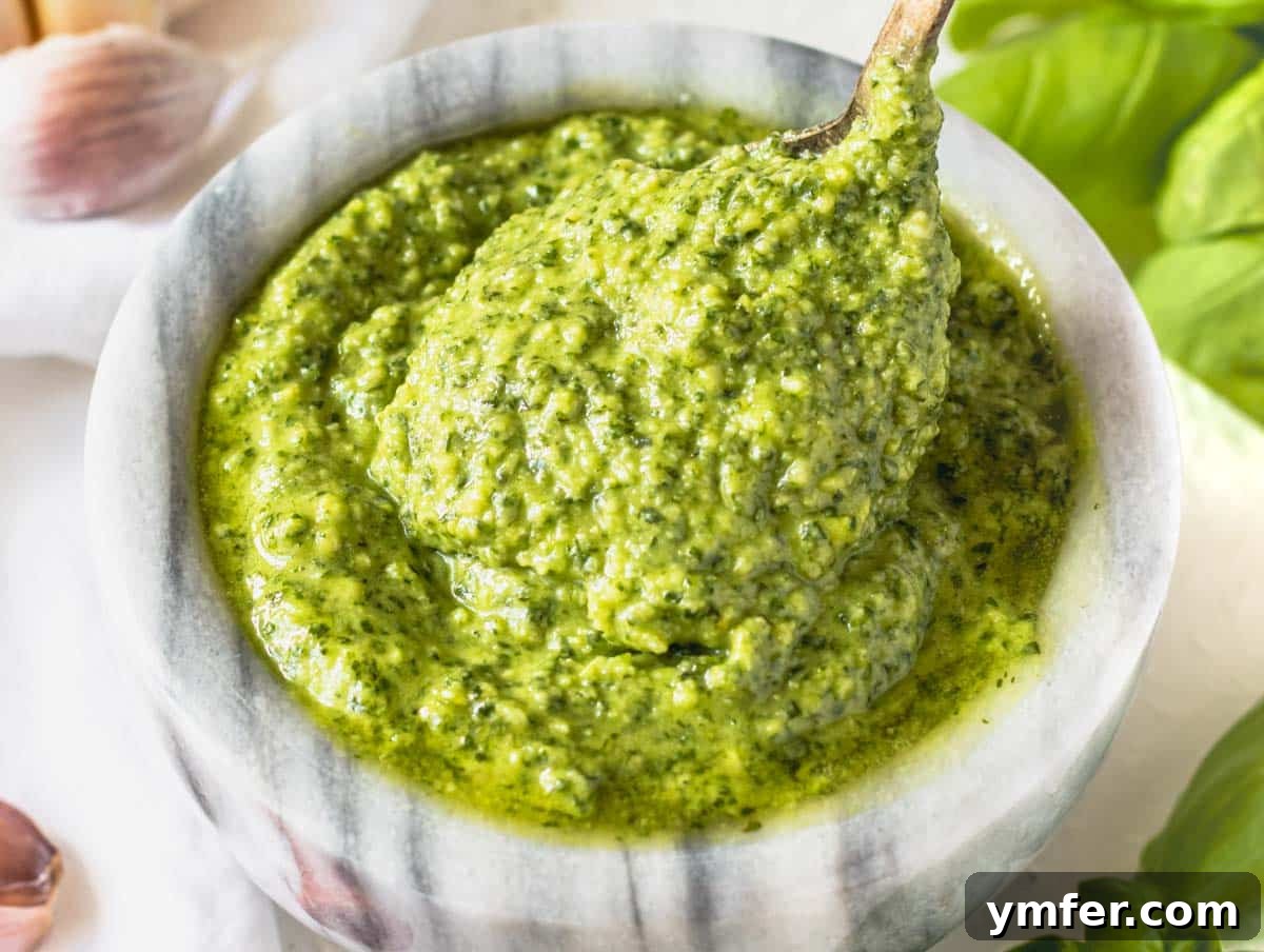 Fresh Basil Pesto 3 Basil pesto in a stone bowl with a silver spoon