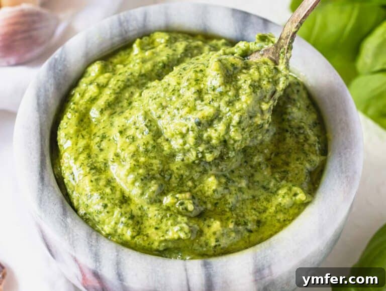 Basil pesto with a silver spoon