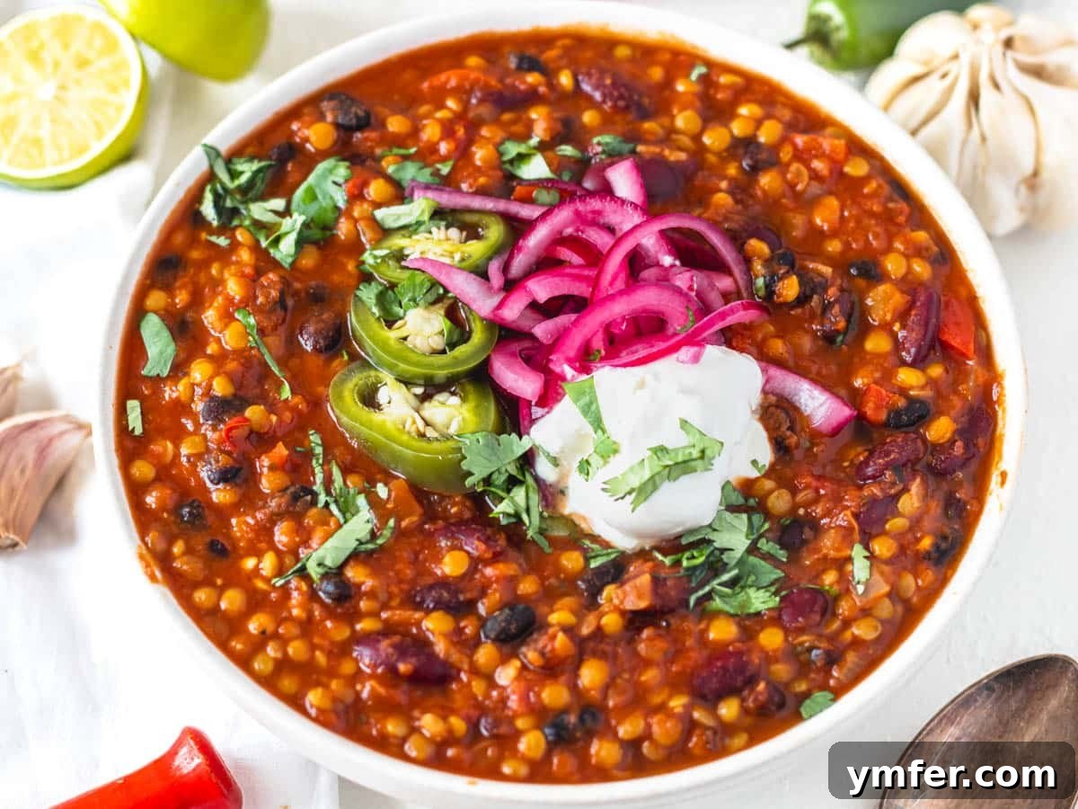 Fifteen Fantastic Black Bean Feasts 10 lentil chili with sour cream and pickled jalapenos in a bowl