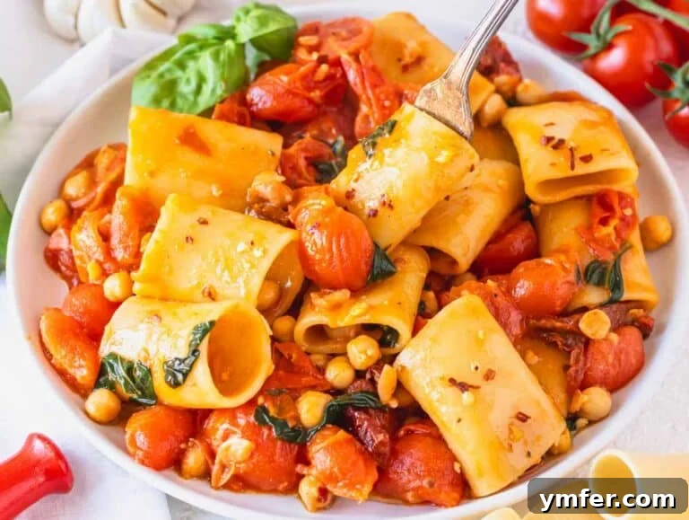 Paccheri: Italy's Grand Tubes 19 paccheri pasta with a fork on a white plate
