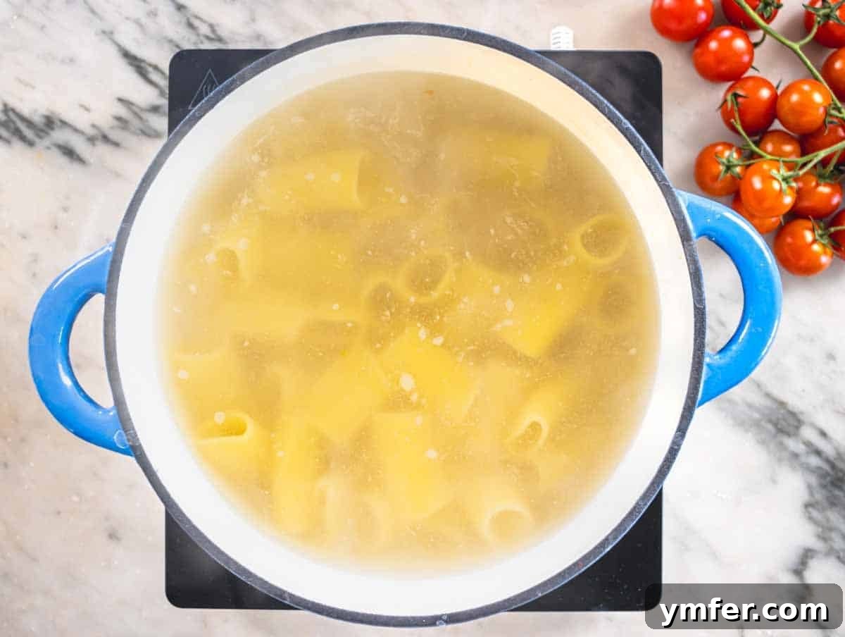 Paccheri: Italy's Grand Tubes 8 paccheri pasta cooking in a blue pot