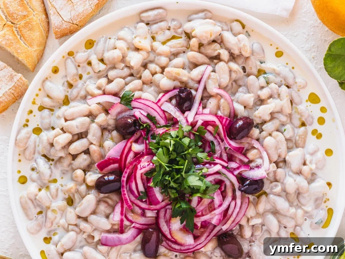 Piyaz Zesty Turkish White Bean Salad 15 Beautifully plated Piyaz salad garnished with marinated red onions and fresh parsley, ready to be served
