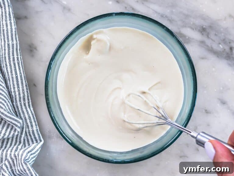 Creamy, smooth tahini sauce in a glass bowl