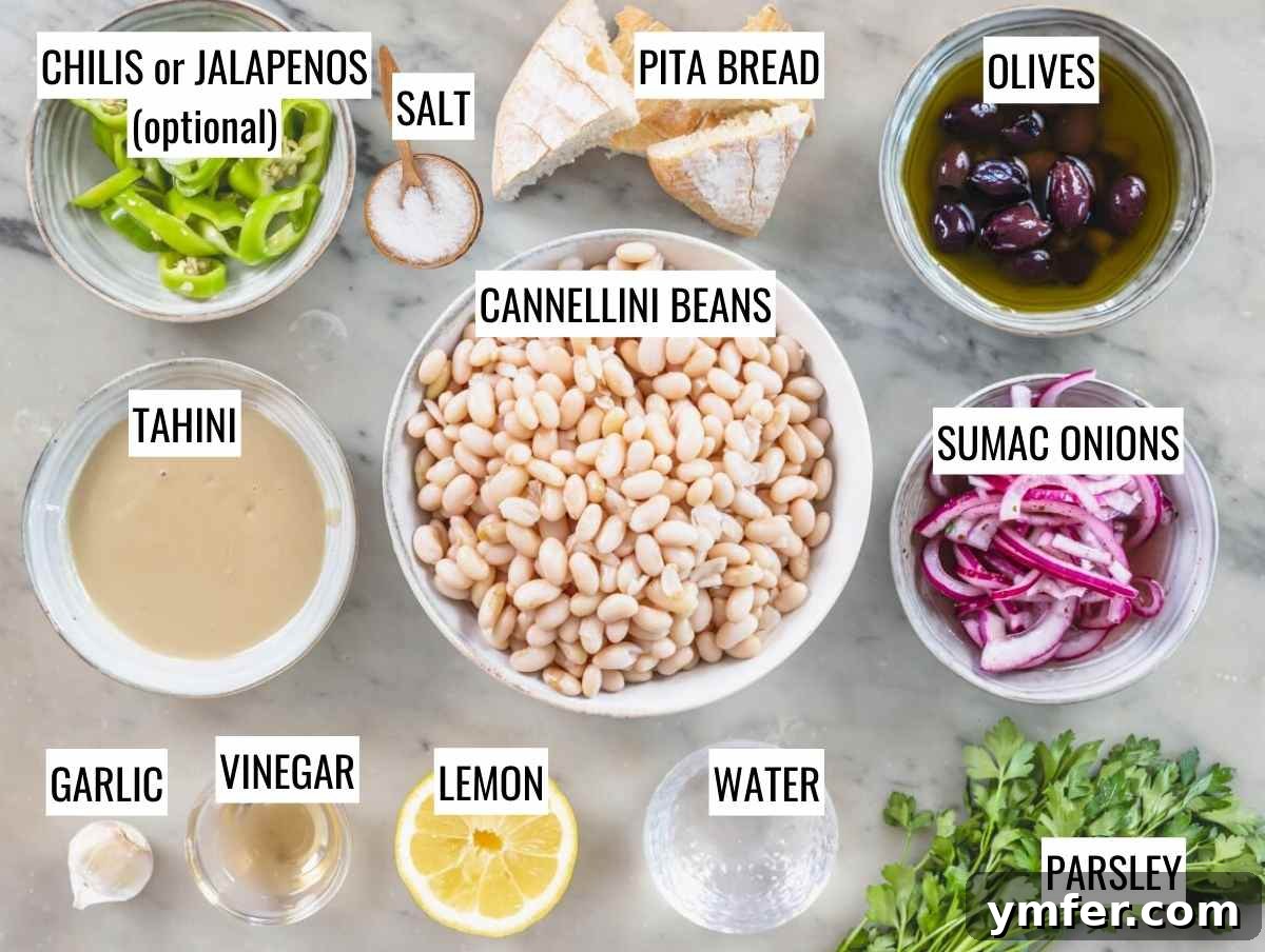 Piyaz Zesty Turkish White Bean Salad 7 All fresh ingredients neatly arranged for making Fasulye Piyazi: white beans, red onion, olives, parsley, tahini, lemon, vinegar, garlic, and salt