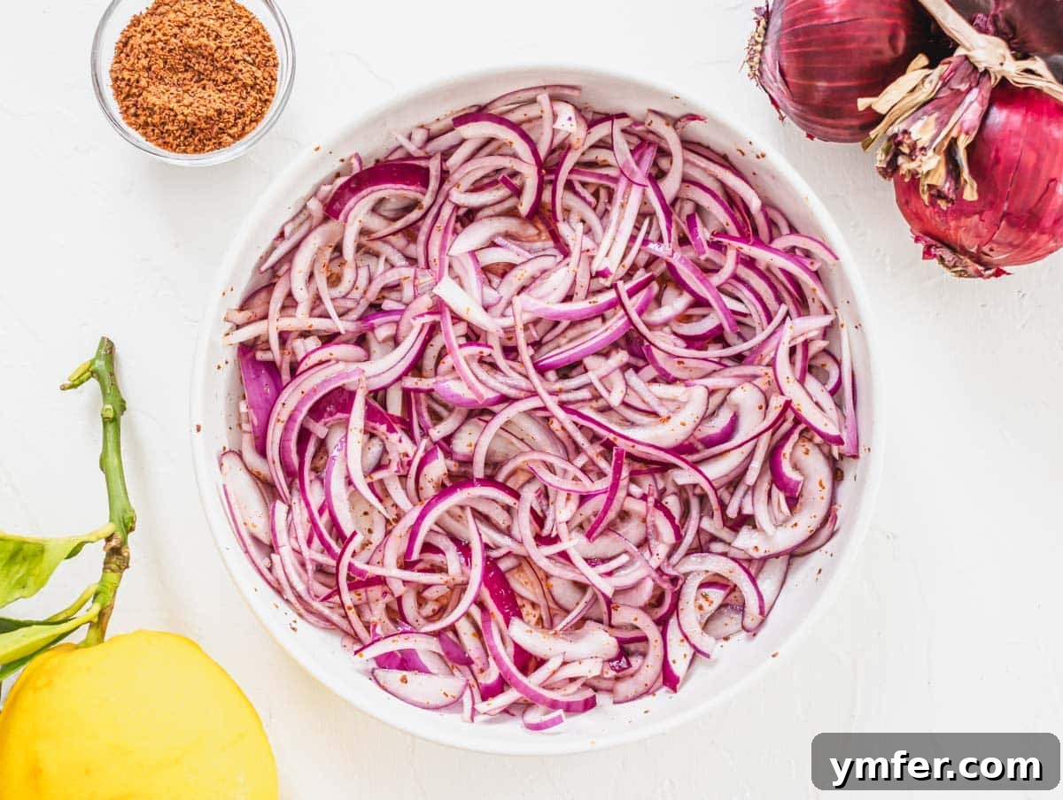 Piyaz Zesty Turkish White Bean Salad 10 Thinly sliced red onions marinating with sumac and lemon juice in a white bowl