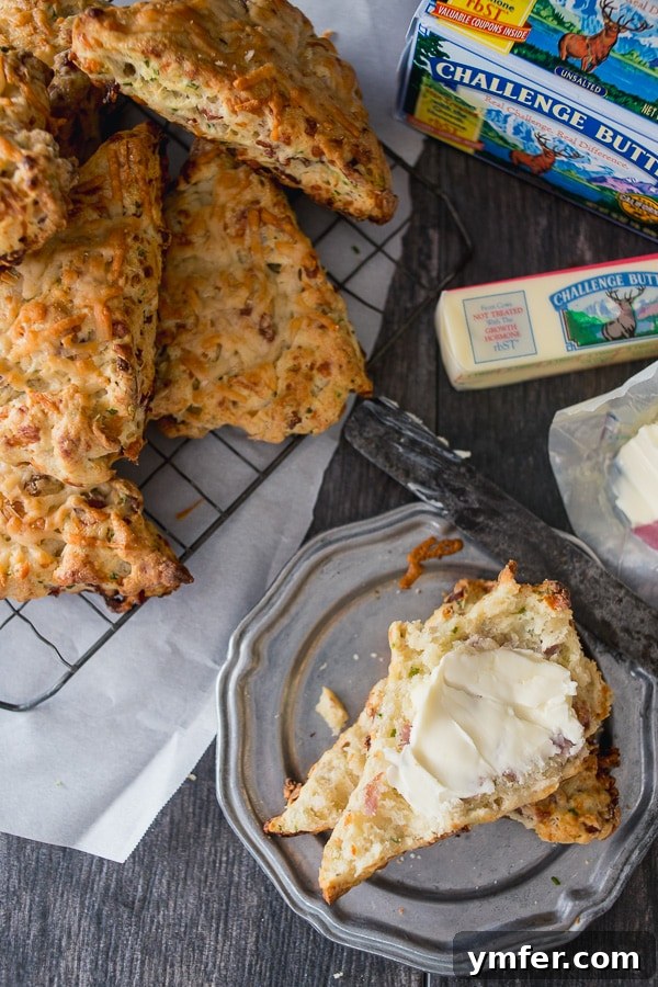 Savory Parmesan Prosciutto Scones 3 A close-up of a perfectly baked Parmesan Prosciutto Scone, showcasing its golden crust, flaky layers, and savory fillings of cheese and ham.