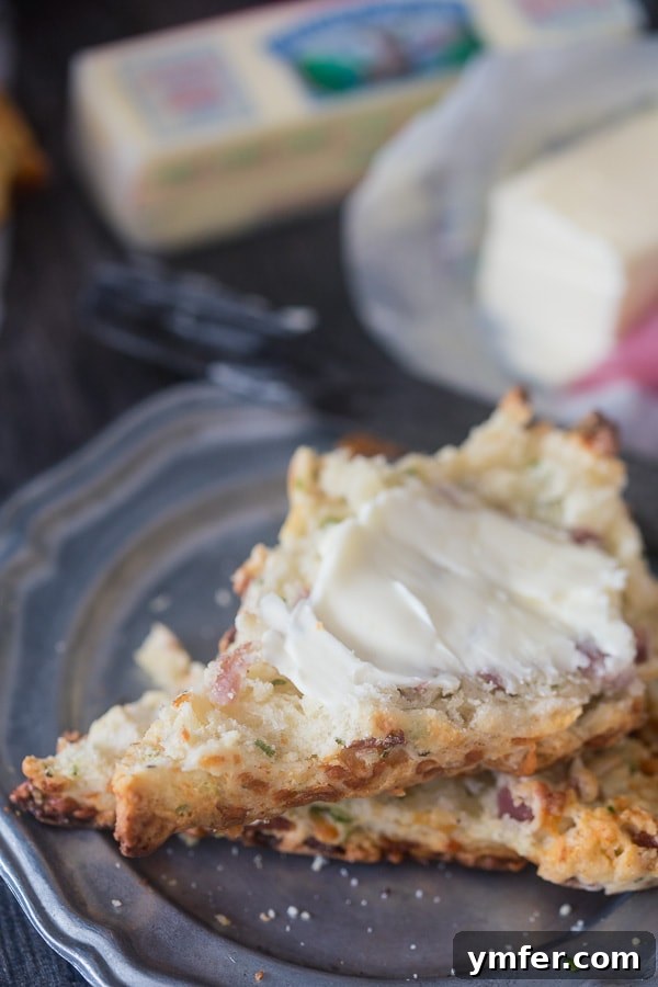 Savory Parmesan Prosciutto Scones 4 Freshly baked Parmesan Prosciutto Scones arranged beautifully on a wire cooling rack, ready to be served and enjoyed.