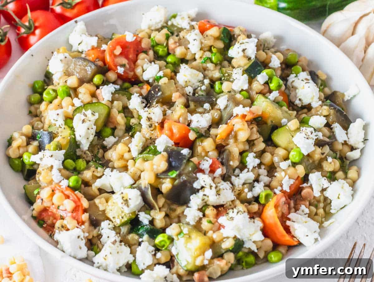 Sardinia's Toasted Pearl Pasta 5 A vibrant fregola pasta recipe with an array of colorful vegetables, showcasing a healthy and appealing meal.