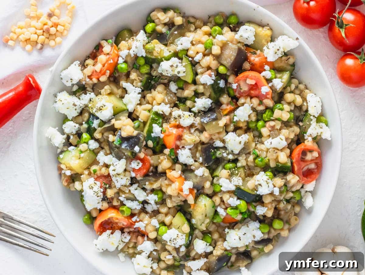 Sardinia's Toasted Pearl Pasta 7 Fregola pasta with colorful vegetables and crumbled feta cheese as a delicious topping.